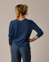 Navy blue mesh pullover with long sleeves shown from back view on model
