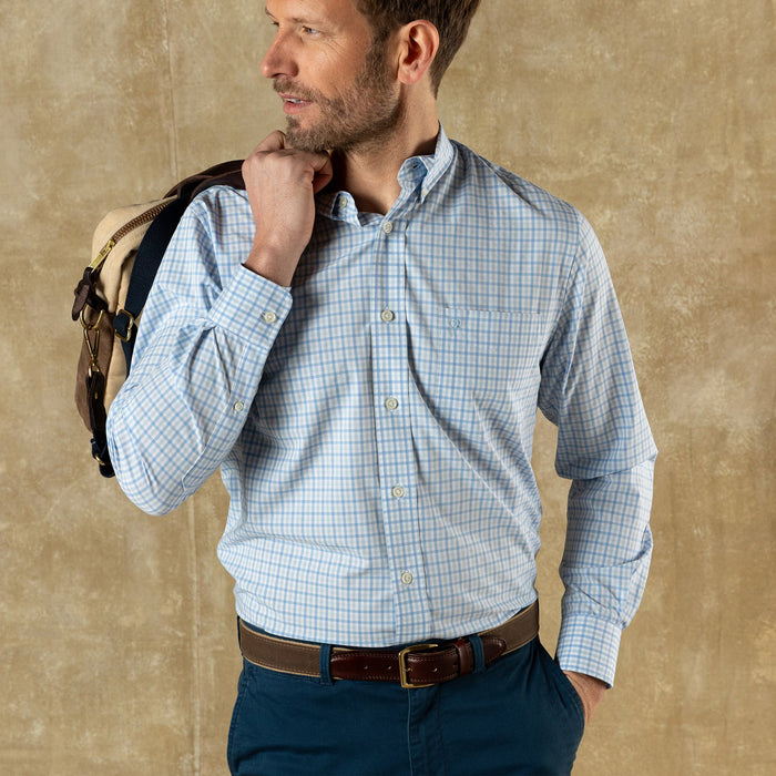 Light blue gingham check dress shirt on man with navy pants and brown belt
