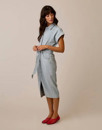 Light wash denim midi shirt dress with belt tie and cap sleeves, side view on model
