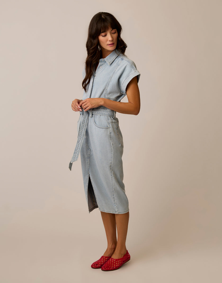 Light wash denim midi shirt dress with belt tie and cap sleeves, side view on model