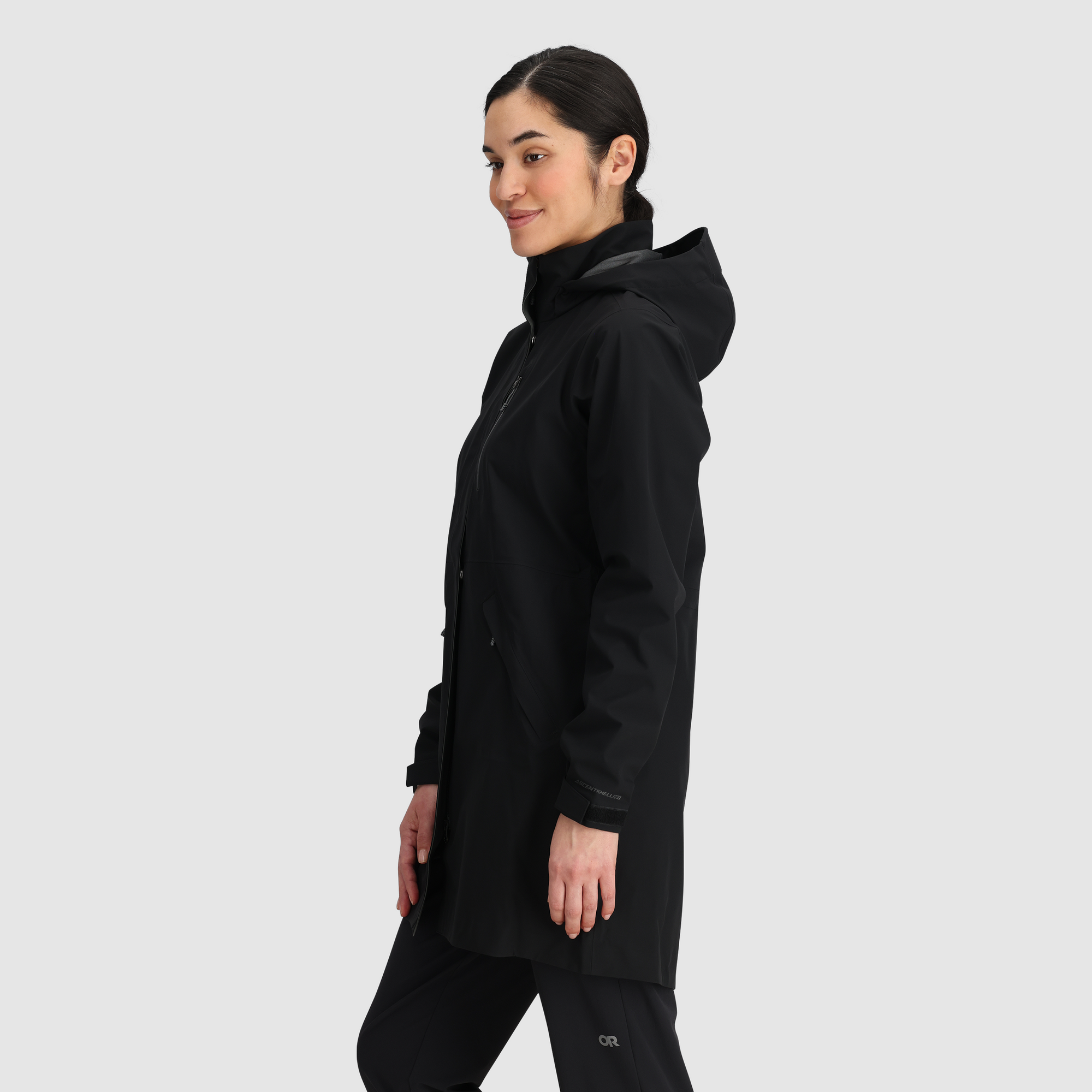 Women's long black hooded rain trench coat with zip front, side view