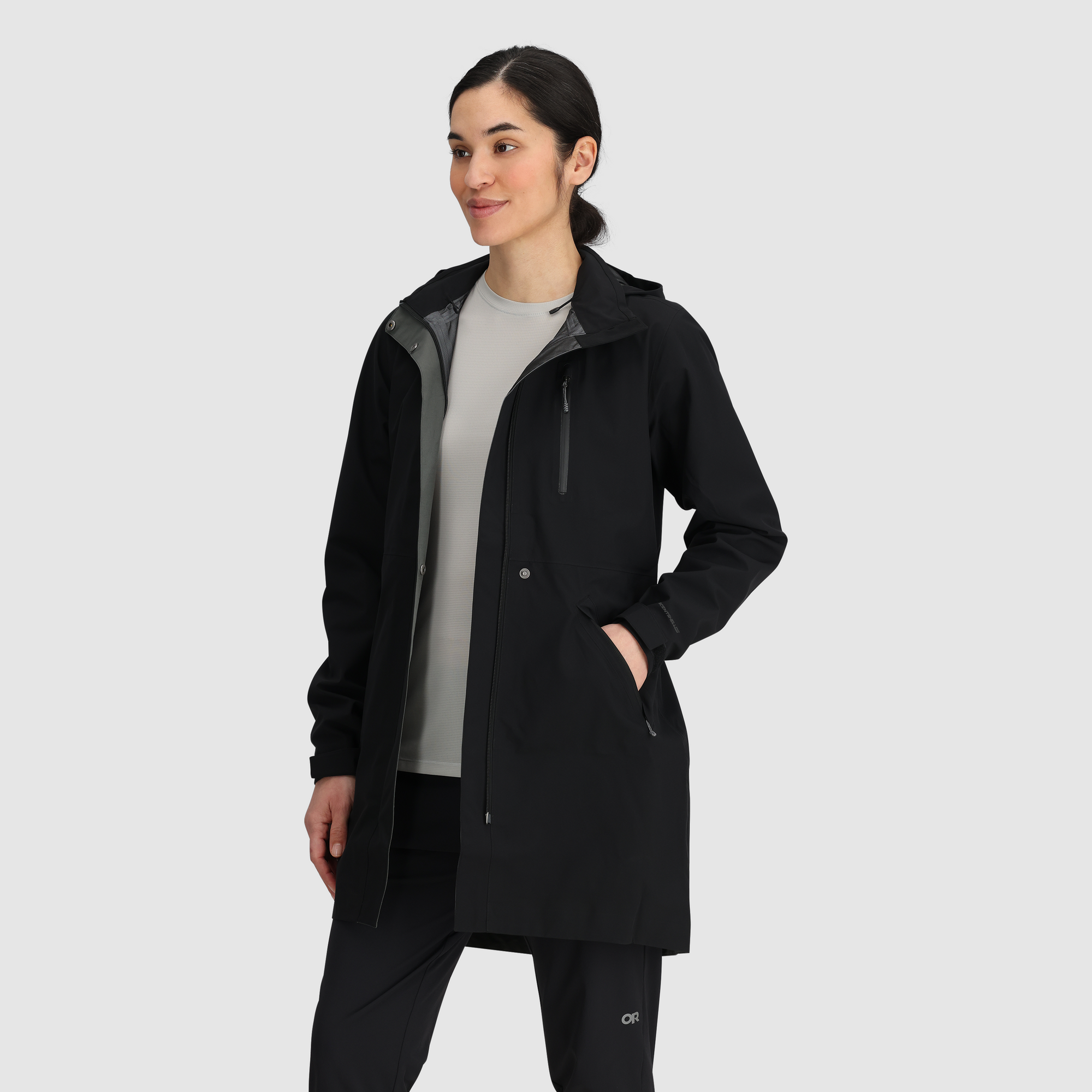 Black long hooded rain trench coat with chest zip pocket, worn open, front angle view