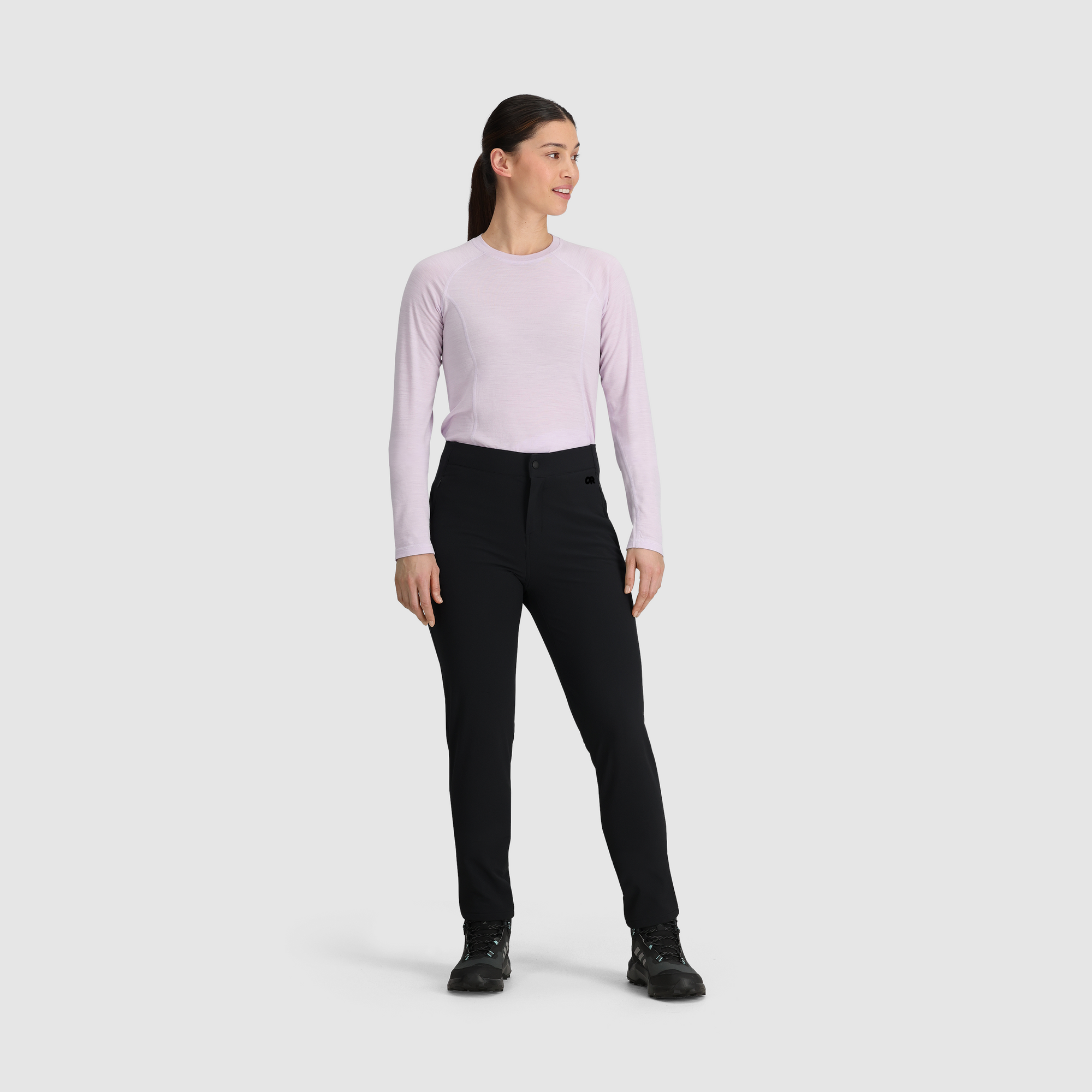 Women's black fleece-lined slim pants with button closure, shown front view with hiking boots