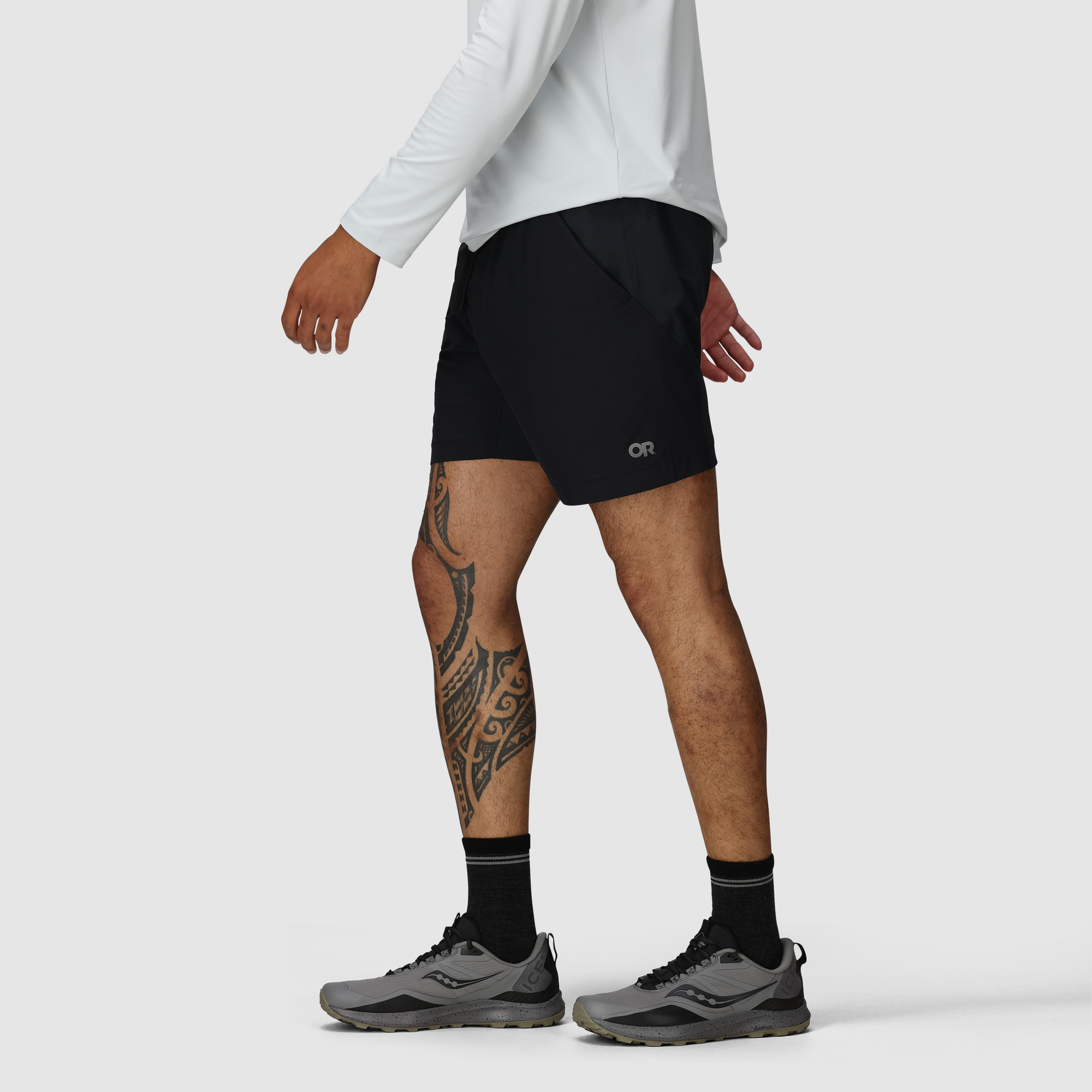 Black athletic shorts with 7-inch inseam worn with running shoes, side view