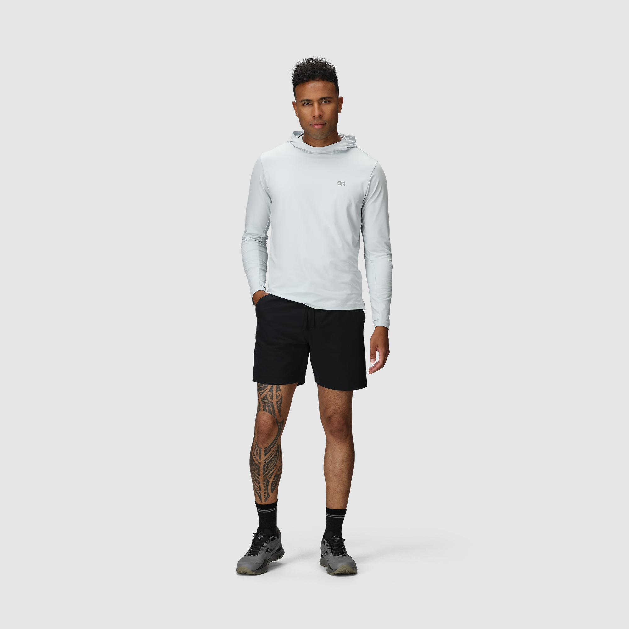 Black athletic shorts with side pockets worn by male model in studio setting