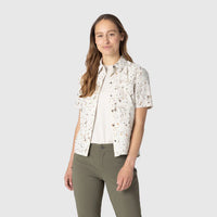 White short sleeve button-up shirt with speckled pattern, worn with olive green pants
