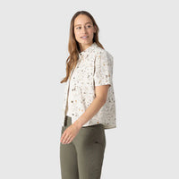 Women's short sleeve button-up shirt with speckled pattern, worn with olive green pants