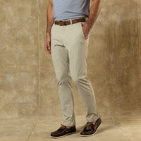Light beige chino pants worn with brown leather belt and boat shoes