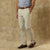 Light beige chino pants worn with brown leather belt and boat shoes