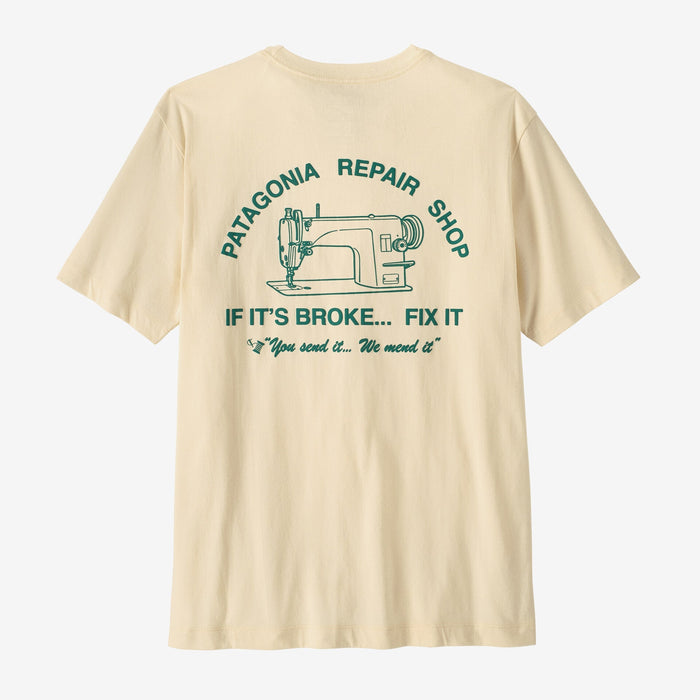 Cream colored t-shirt with repair shop graphic and sewing machine illustration on back