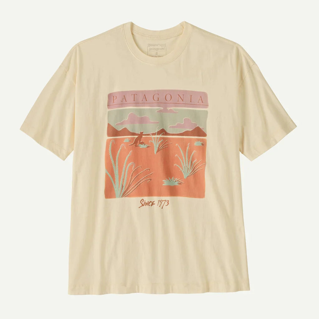 Cream colored oversized t-shirt with desert landscape graphic featuring mountains and desert plants
