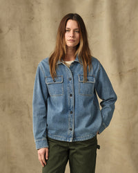 Women's long-sleeve denim shirt with dual chest pockets and snap buttons, front view