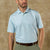 Light blue polo shirt with small pattern, short sleeves, three-button placket, worn with khaki pants