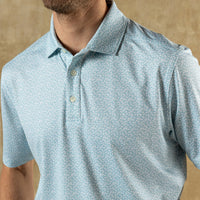 Light blue short sleeve polo shirt with small floral pattern and collar detail