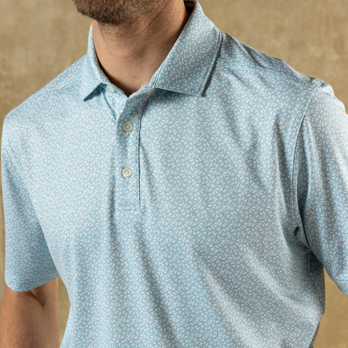 Light blue short sleeve polo shirt with small floral pattern and collar detail