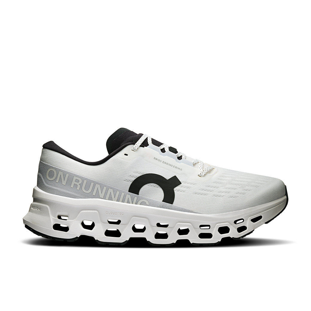White running shoe with distinctive holed sole, side profile view showing mesh upper