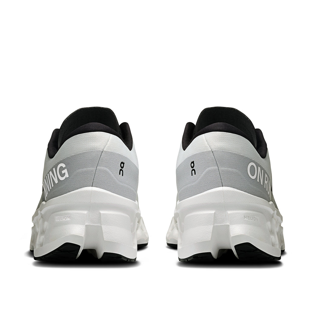 Running shoes rear view showing white and gray gradient design with chunky sole