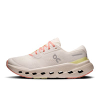 Light colored running shoe with distinctive perforated sole and coral laces, side profile view