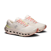Pair of women's running shoes in off-white with coral laces and chunky CloudTec sole, three-quarter view