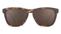 Tortoiseshell sunglasses with dark brown lenses, front view on white background