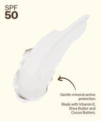 White mineral sunscreen lotion with SPF 50 protection, showing creamy texture and application streak