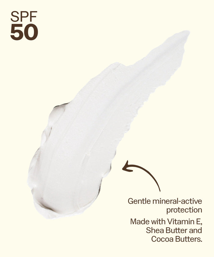 White mineral sunscreen lotion with SPF 50 protection, showing creamy texture and application streak