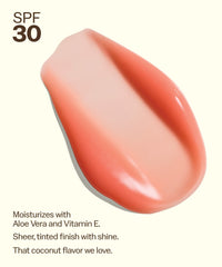 Coral pink tinted lip balm with SPF 30 showing creamy texture and shine