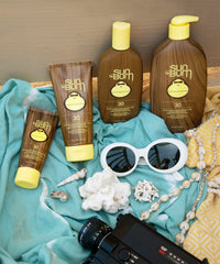 Brown sunscreen lotion bottles with yellow pump dispensers in beach lifestyle setting