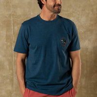 Heathered blue short sleeve t-shirt with chest pocket and small circular logo patch