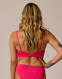 Women's bikini top in bright pink, back view showing adjustable straps and bralette style