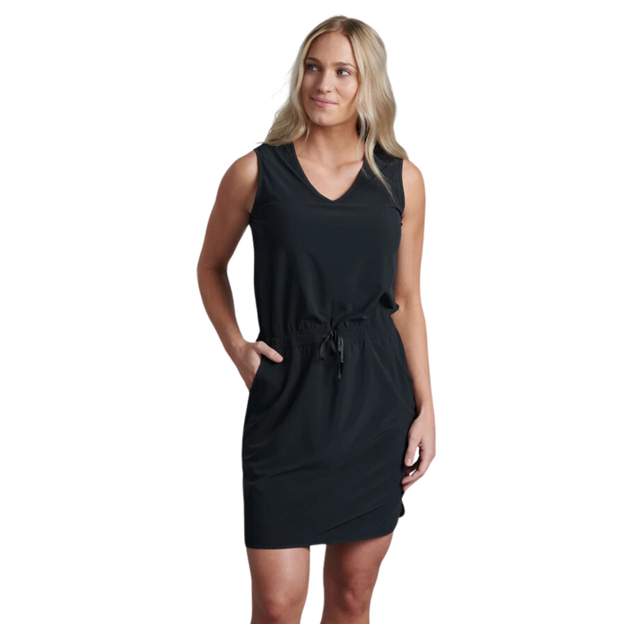 Black sleeveless dress with v-neck and drawstring waist, worn by woman with hands in pockets