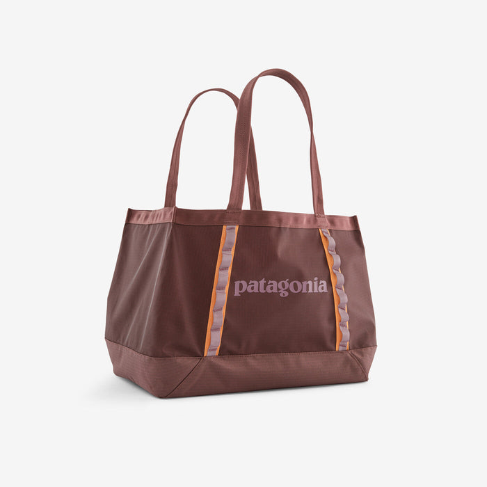 Large tote bag in dusty rose color with orange accent stripes and dual handles