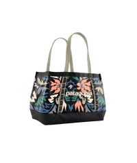 Tote bag with vibrant floral pattern and black trim, featuring dual handles