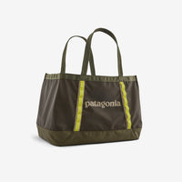 Olive green tote bag with yellow accent straps and dual handles on white background