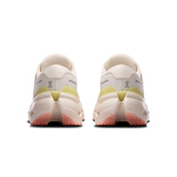 Women's running shoes rear view showing chunky midsole, yellow-green heel tab, and coral outsole