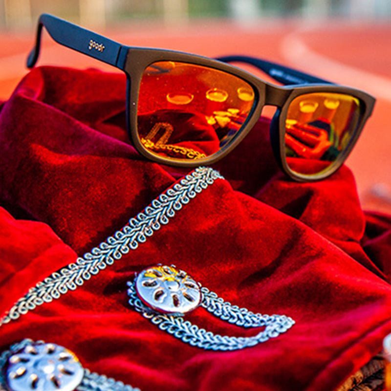 Dark framed sunglasses with orange mirrored lenses on red paisley bandana