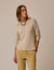 Light beige marled knit sweater on model with round neckline and relaxed fit