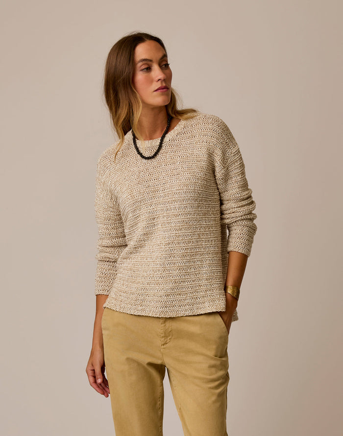 Light beige marled knit sweater on model with round neckline and relaxed fit
