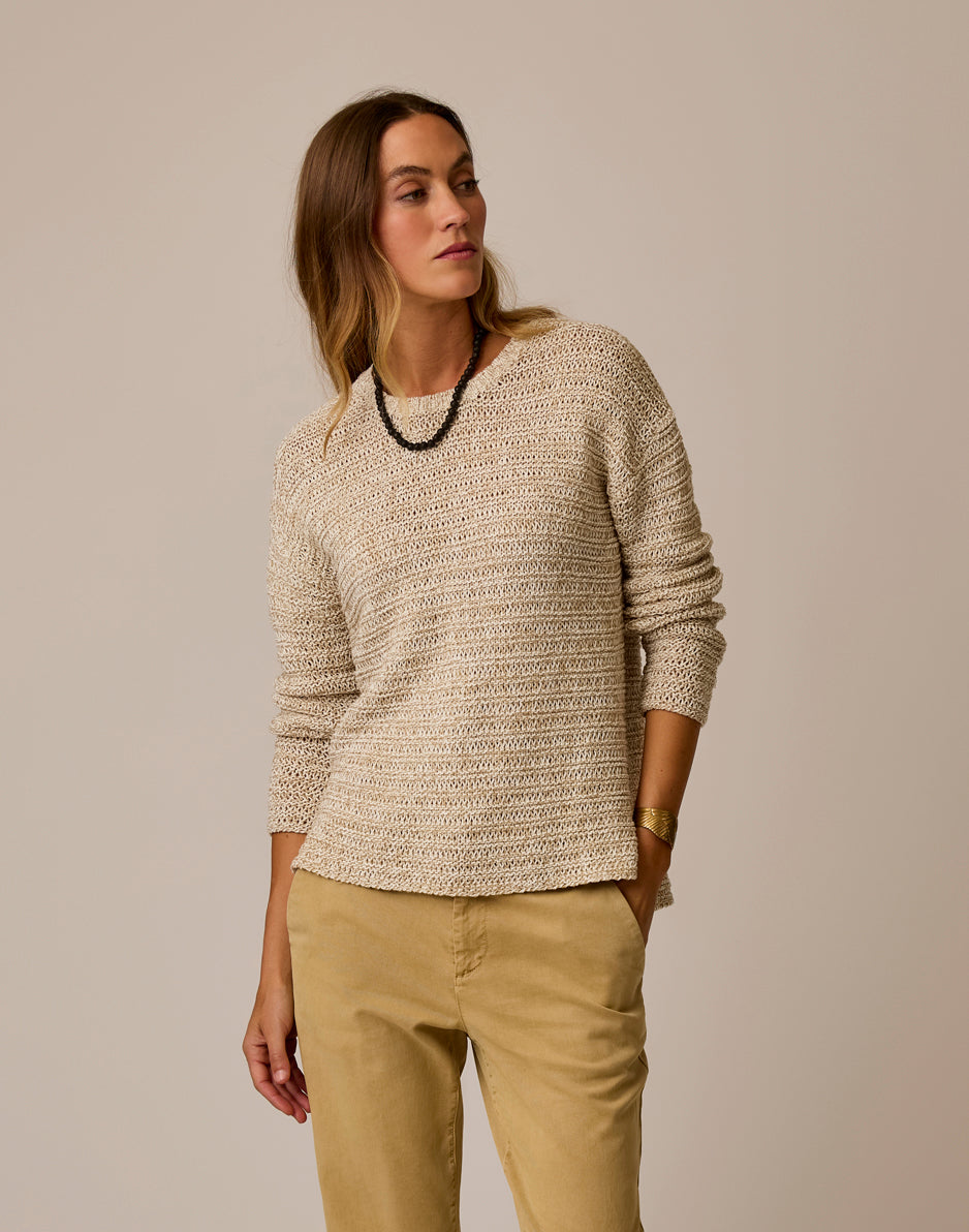 Light beige marled knit sweater on model with round neckline and relaxed fit