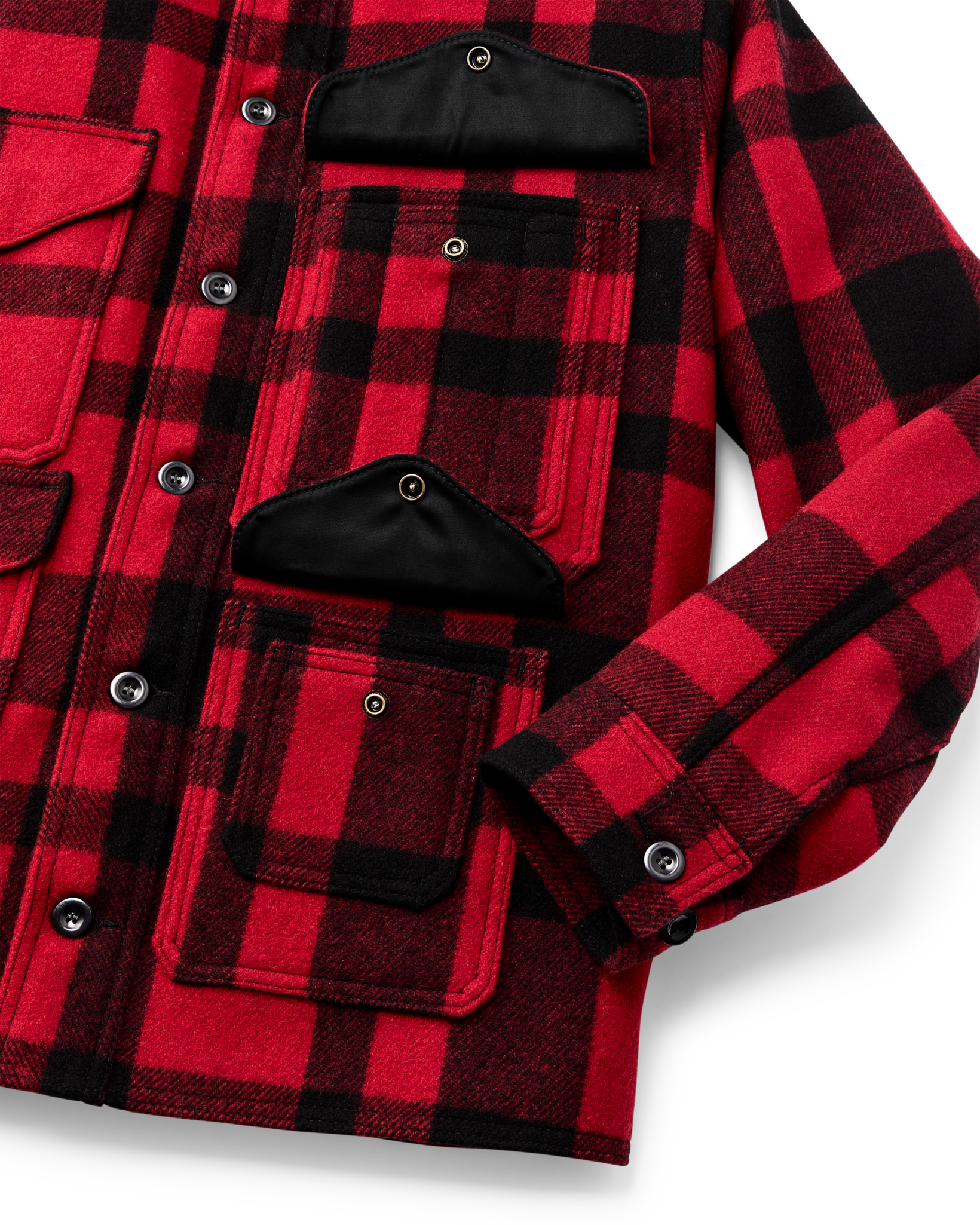 Red and black plaid wool cruiser jacket detail showing multiple pockets and snap buttons