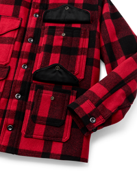 Red and black plaid wool cruiser jacket detail showing multiple pockets and snap buttons