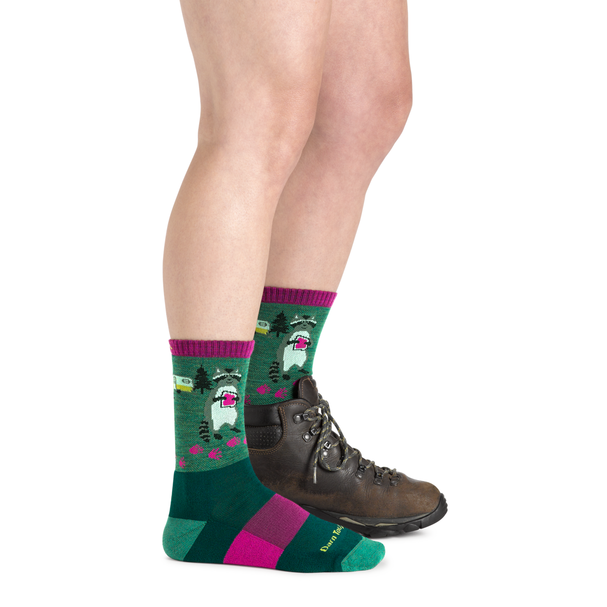 Green crew socks with raccoon camping pattern and pink accents, worn with hiking boot