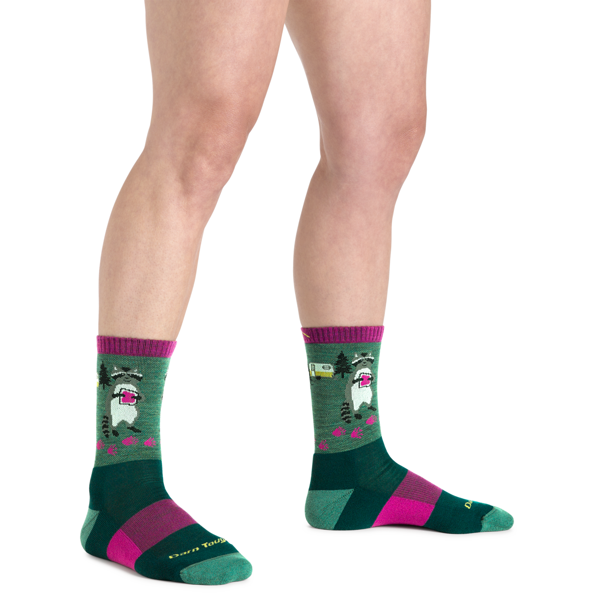 Crew-length novelty socks with raccoon camping pattern, green and magenta colorway, on-model view