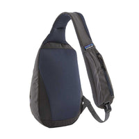 Single-strap sling bag in navy and charcoal with zippered front pocket, angled view
