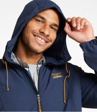 Man wearing dark navy hooded full-zip jacket with gold drawstrings, close-up front view