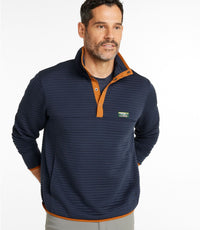 Man wearing navy blue knit pullover with orange trim and snap collar