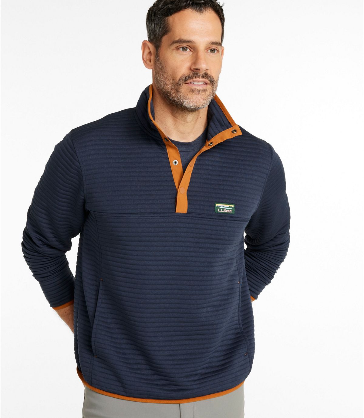 Navy knit pullover with quarter-snap collar and orange contrast details, front view