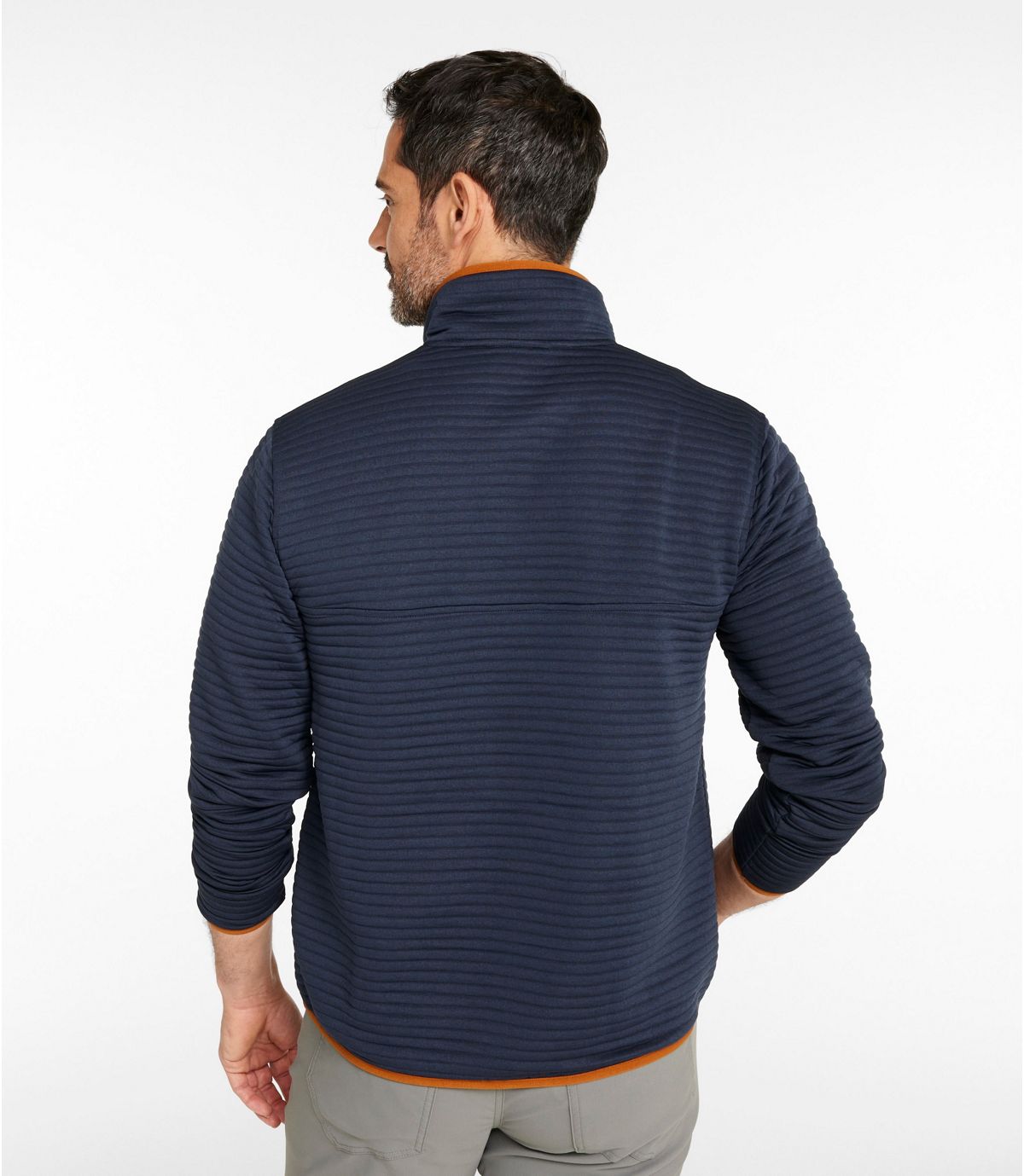 Man wearing navy blue textured knit pullover with quarter-zip collar, back view