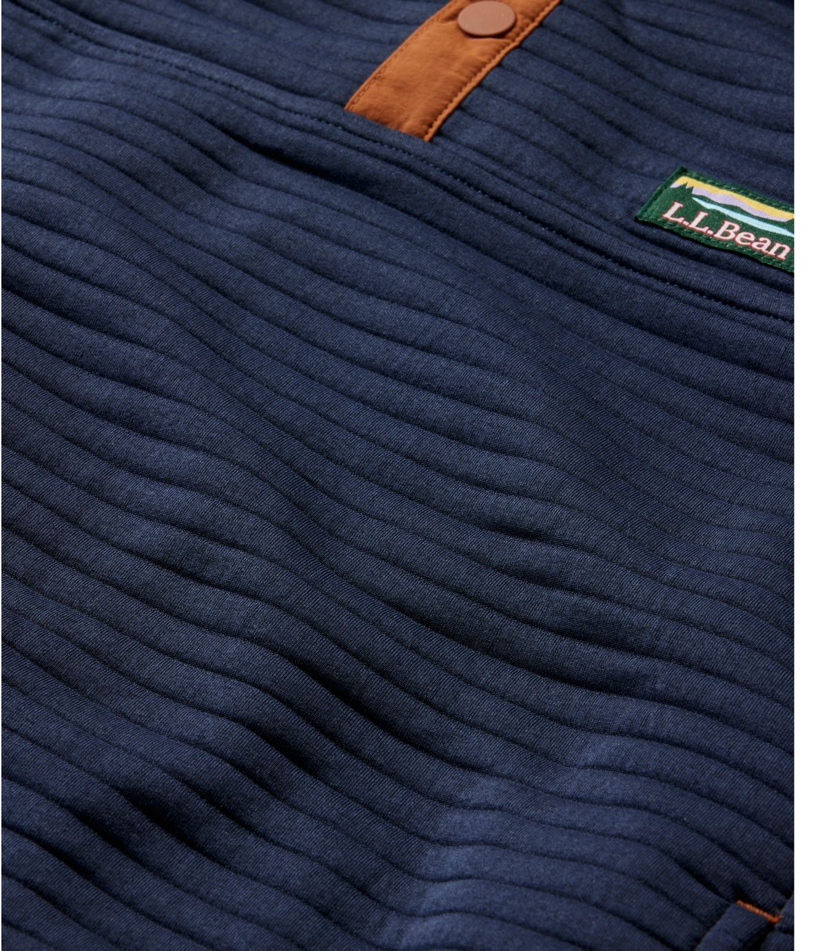 Navy blue quilted knit pullover with leather tab detail and ribbed texture