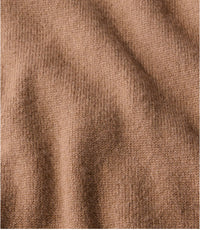 Close-up detail of a fine knit cashmere sweater in warm camel heather, showing texture and drape
